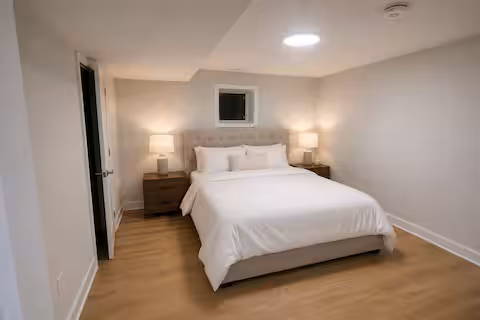 Second bedroom with white bedding and two bedside tables